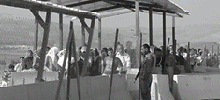 Palestinians wait at a checkpoint.