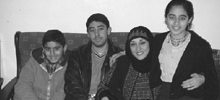 A family smiles for the camera.