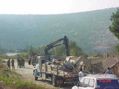 An Israeli truck hauls away the remnants of a Palestinian flower stall.