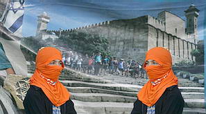 Masked settlers standing next to a banner showing the Tomb of the Patriarchs in Hebron on Sunday. (AP)