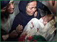 A devastated mother holds her dead infant.