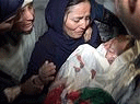 Rima Tmeizi cries, holding the body of her murdered three-month-old son to her body.