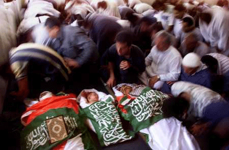The bodies of Mohammed Salameh Tmeizi, 23, Diya Marwan Tmeizi, three months, and Mohammed Hilmy Tmeizi, 17, are lain out before burial.