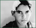 Boy with bandage on his head and sad eyes.