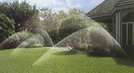 An Israeli lawn is watered with five sprinklers.